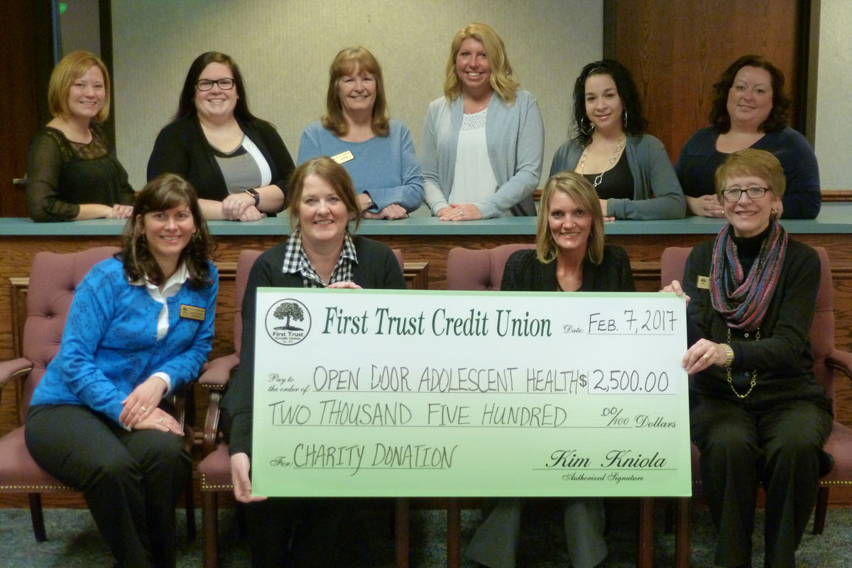 First Trust Credit Union Presents a Check to Their Charity Partner, Open Door Adolescent Health Center to Help Prevent Adolescent Substance Abuse